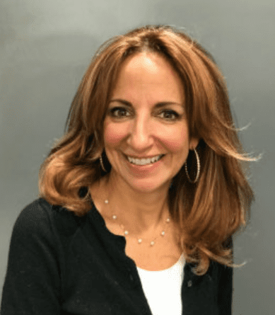 A woman with long hair and wearing a black jacket.