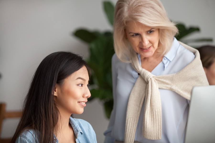 A picture of two women checking something on the laptop