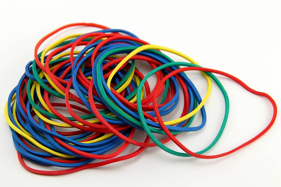 A picture of colorful rubber bands on a white table