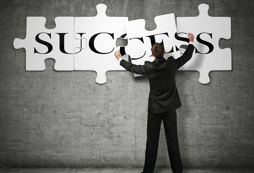 a man putting jigsaw puzzle pieces together to form the word success
