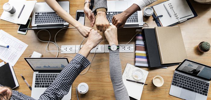 a team working together and fist bumping each other