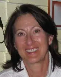 A woman with brown hair smiles for the camera.