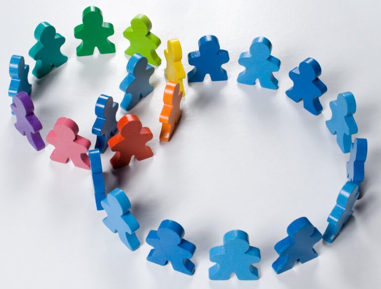 A group of wooden people arranged in a circle.