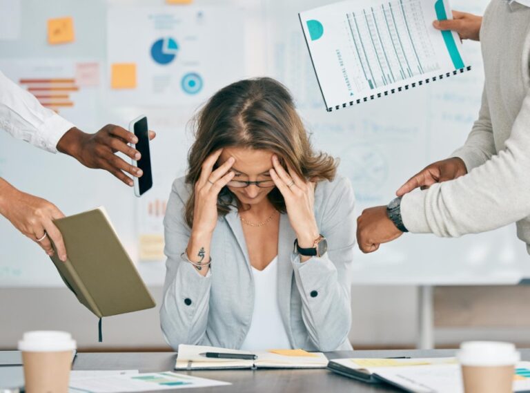 Women sitting at a desk stressed with work