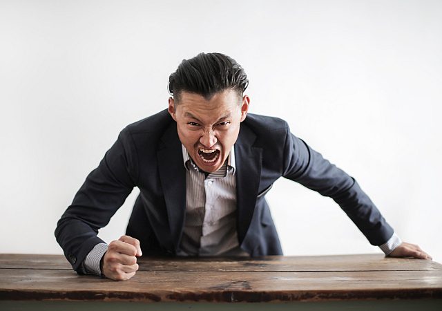 A man in a suit is sitting at the table