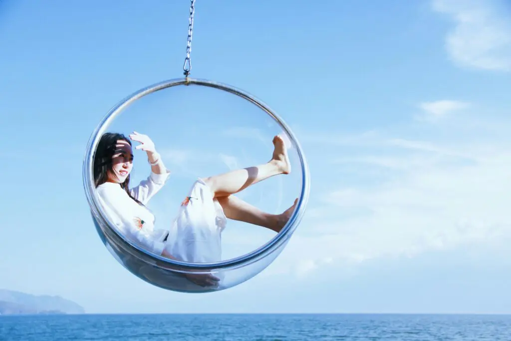 Girl sitting in a bubble above the ocean to avoid destructive patterns 