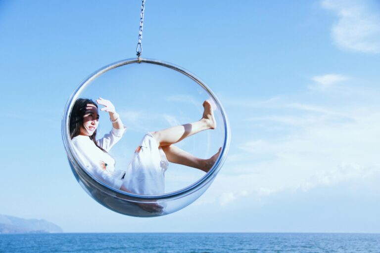 Girl sitting in a bubble above the ocean