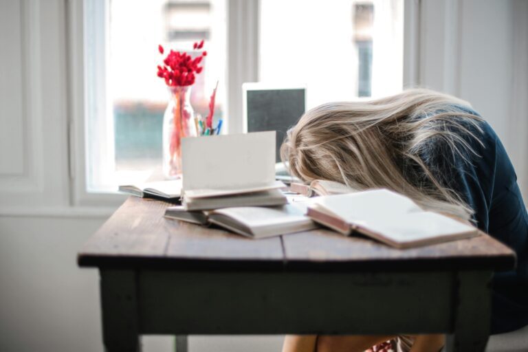 A woman sitting at the table with her head down.