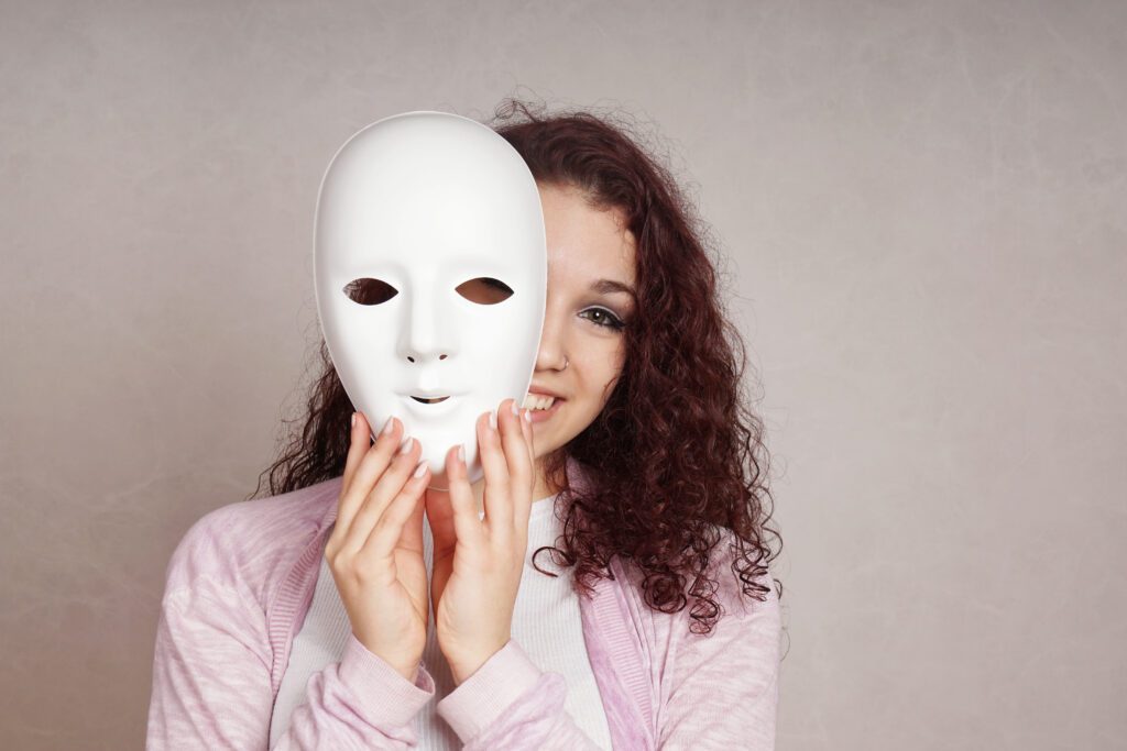 A young woman coming out from her mask of stress to reveal her self-confident and self-aware side