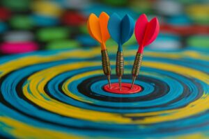 Three colorful darts strike the bullseye of a vibrant painted target, symbolizing focus and recovery from burnout through balance and alignment.