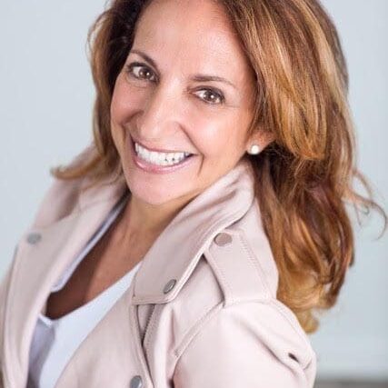 Smiling woman wearing light-colored jacket